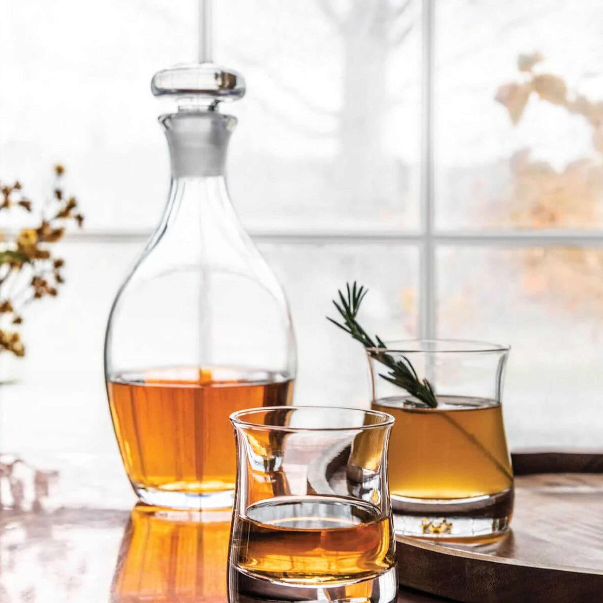 Simon Pearce Shoreham Decanter in front of a window at Addison West