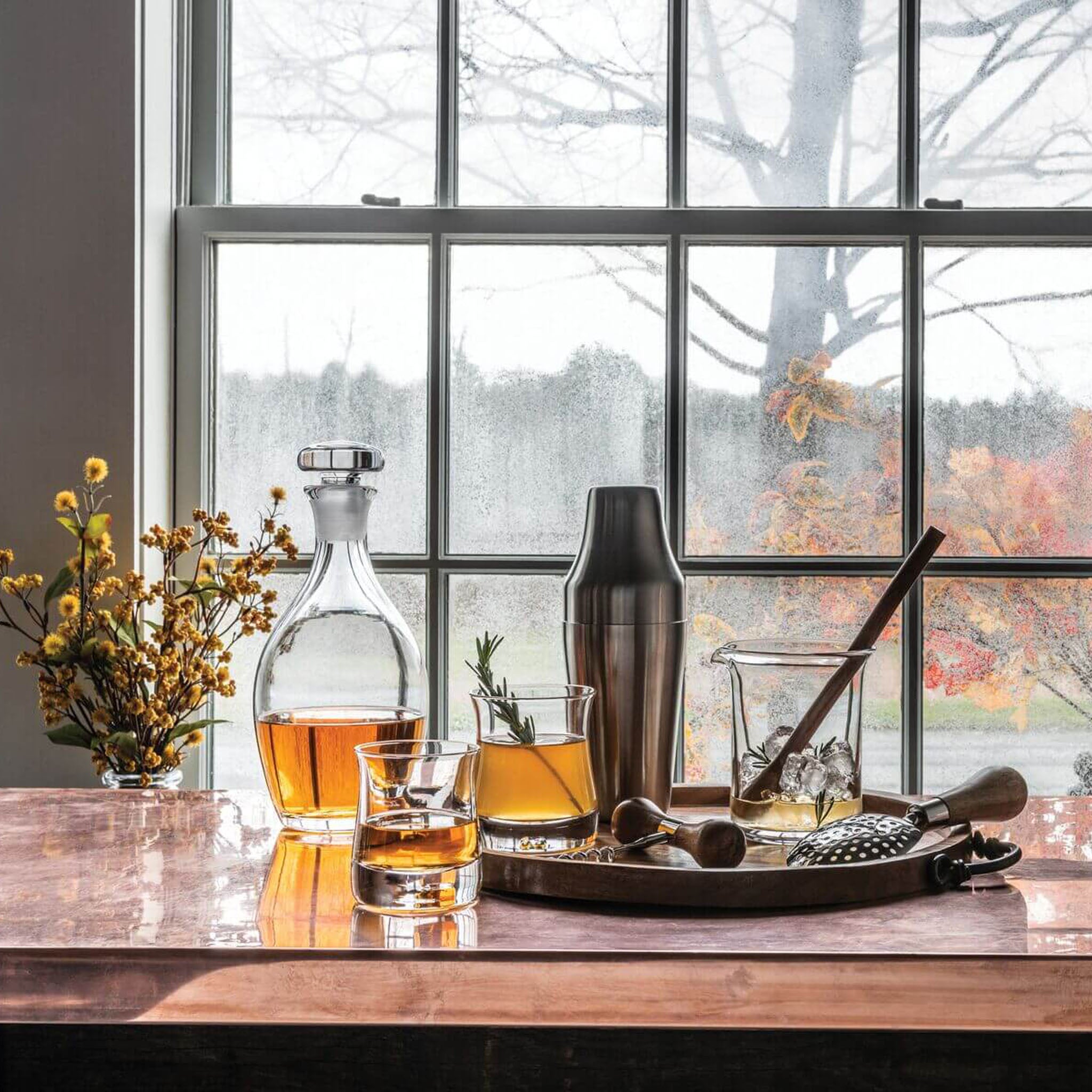 Simon Pearce Shoreham Decanter in front of a window at Addison West