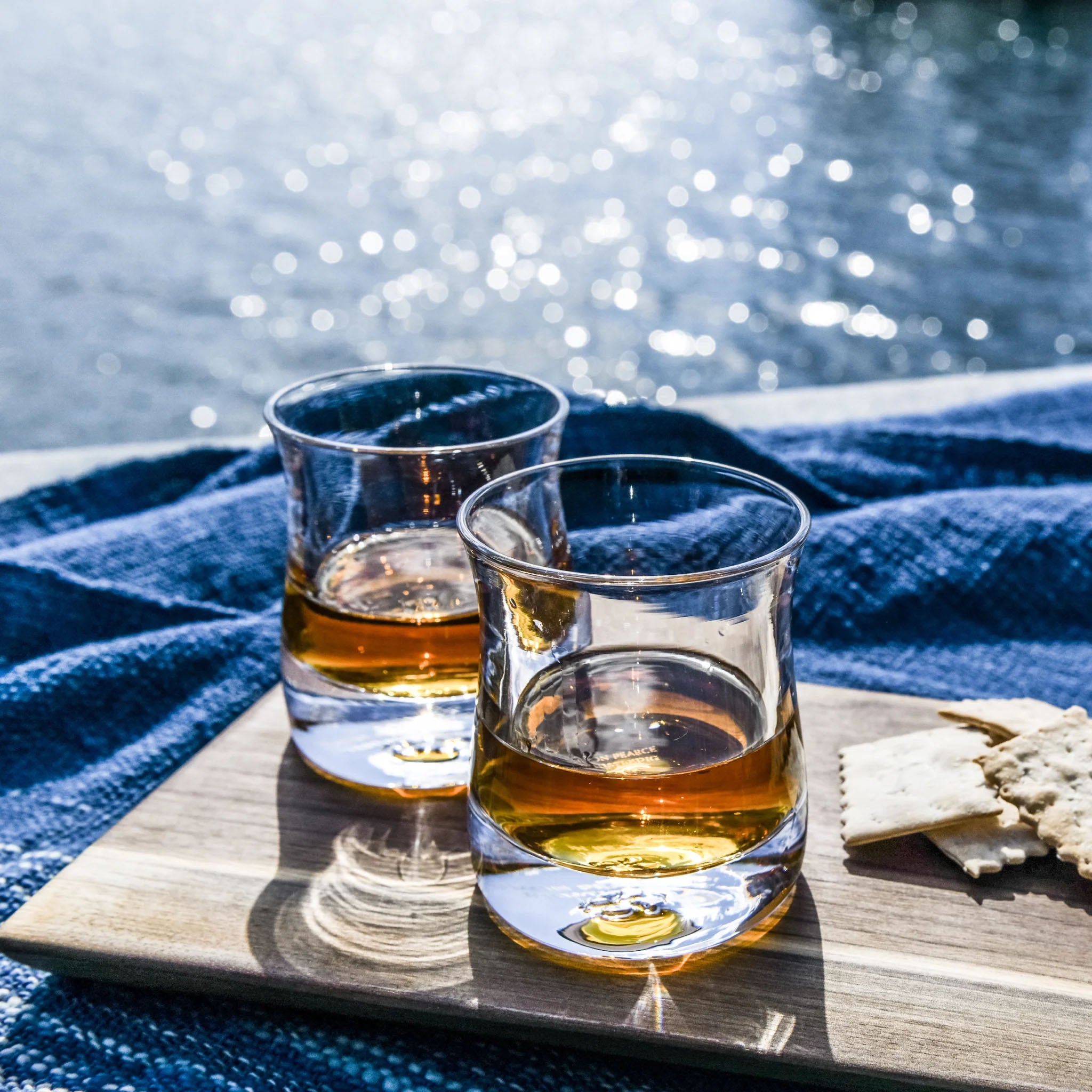 Shoreham Whiskey, Set of 2 on a cheese board in front of a lake at Addison West