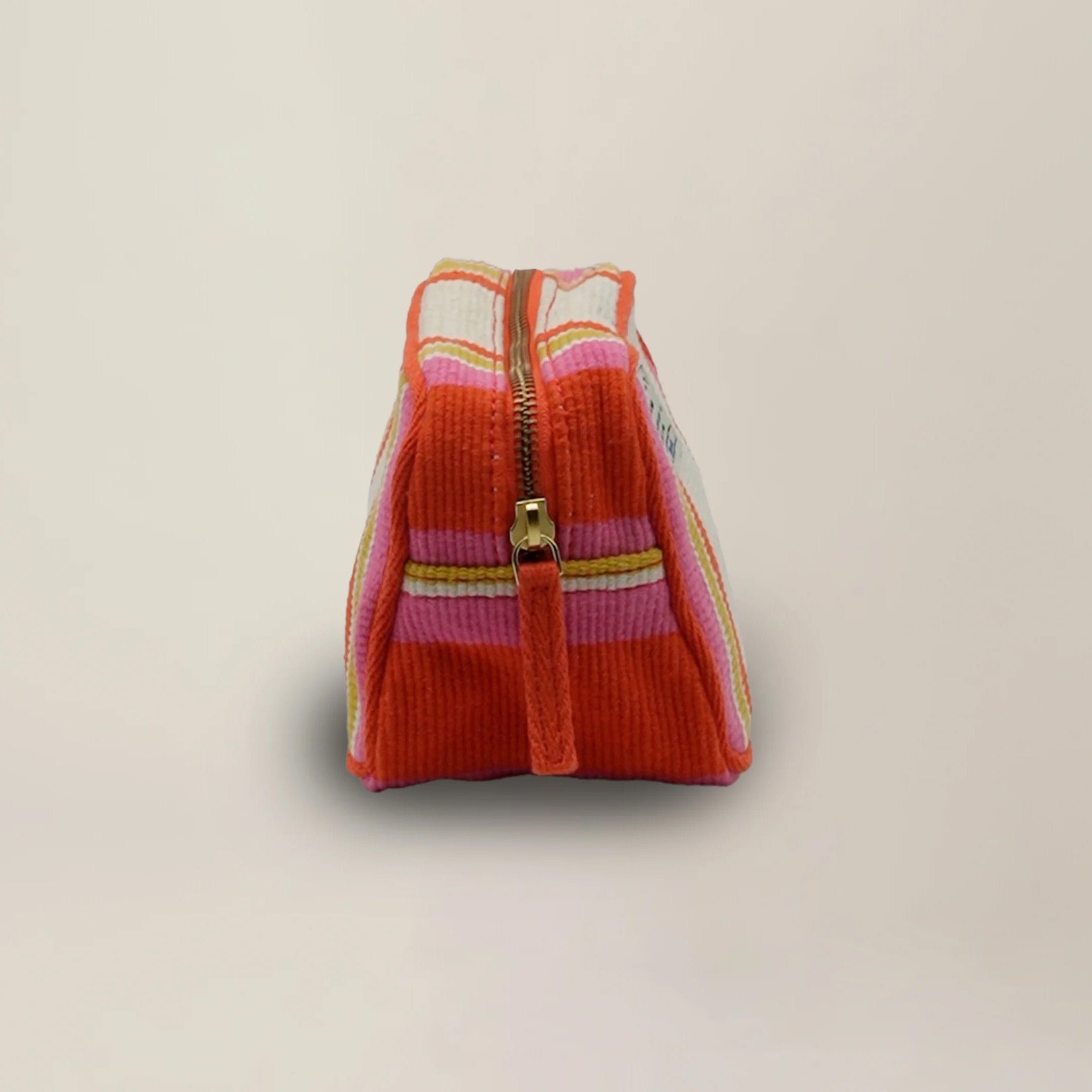 Small Pouch N°42 in Bari Spritz on a beige background at Addison West