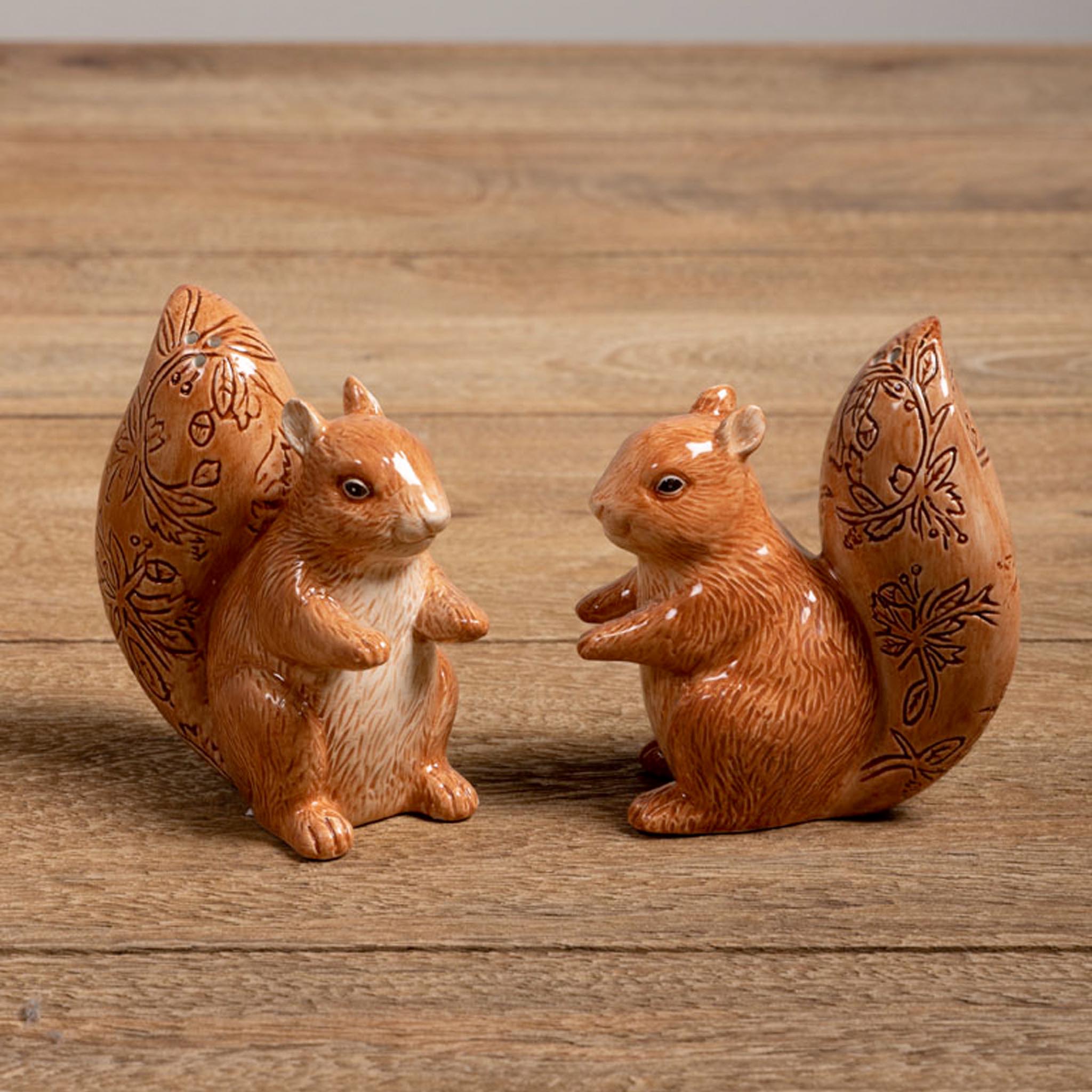 Set of two salt and pepper squirrel shakers on a wooden surface