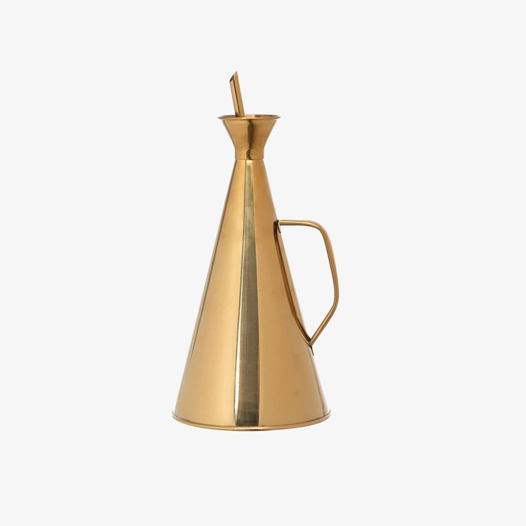 Brass oil dispenser with handle on a white background