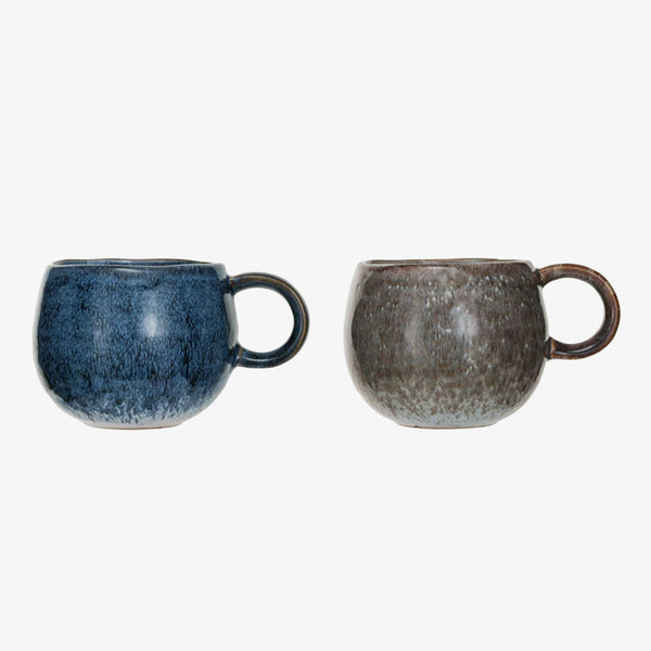 Two round mugs in blue and brown with loop handles on a white background