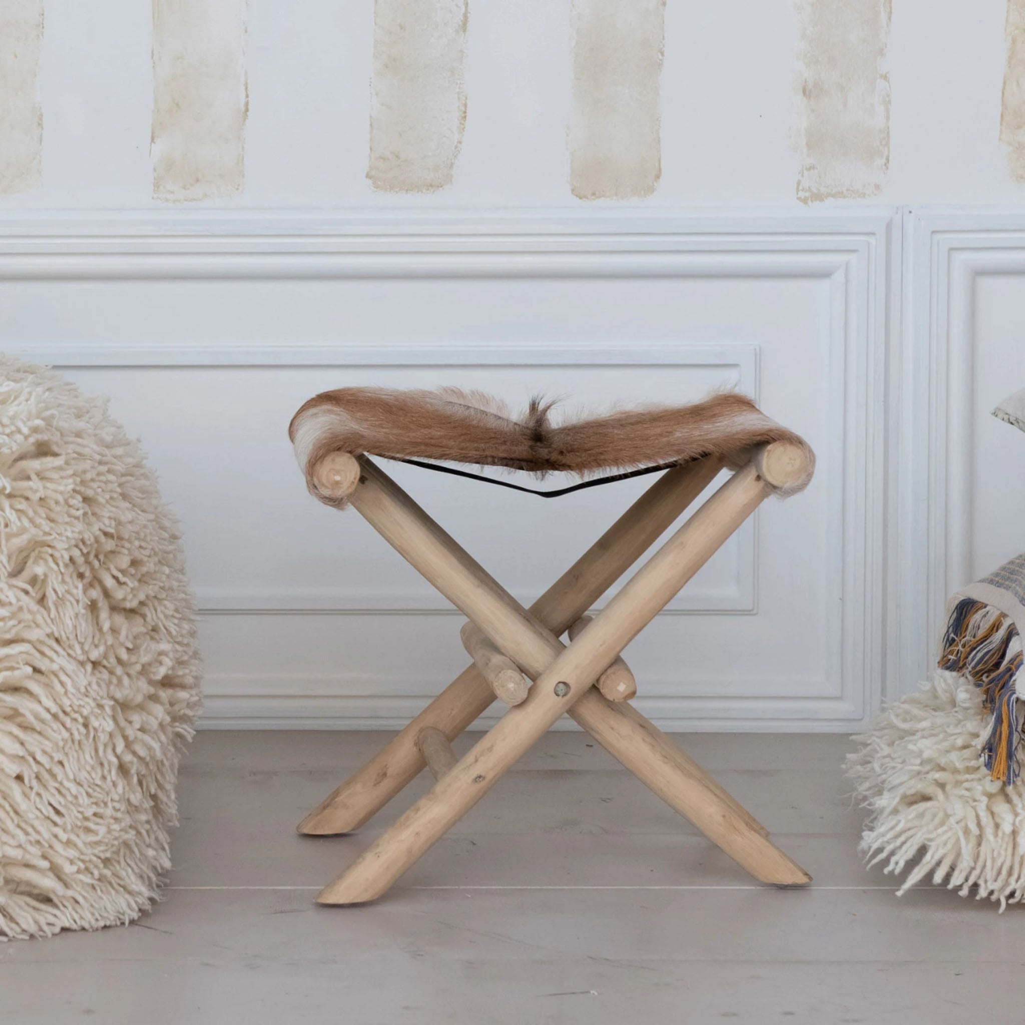 Teakwood and Goat Fur Folding Stool on a white background at Addison West