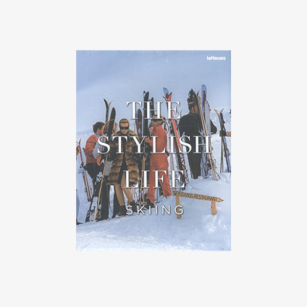 Front cover of book titled 'the stylish life skiing' showing skiers on a mountain on a white background
