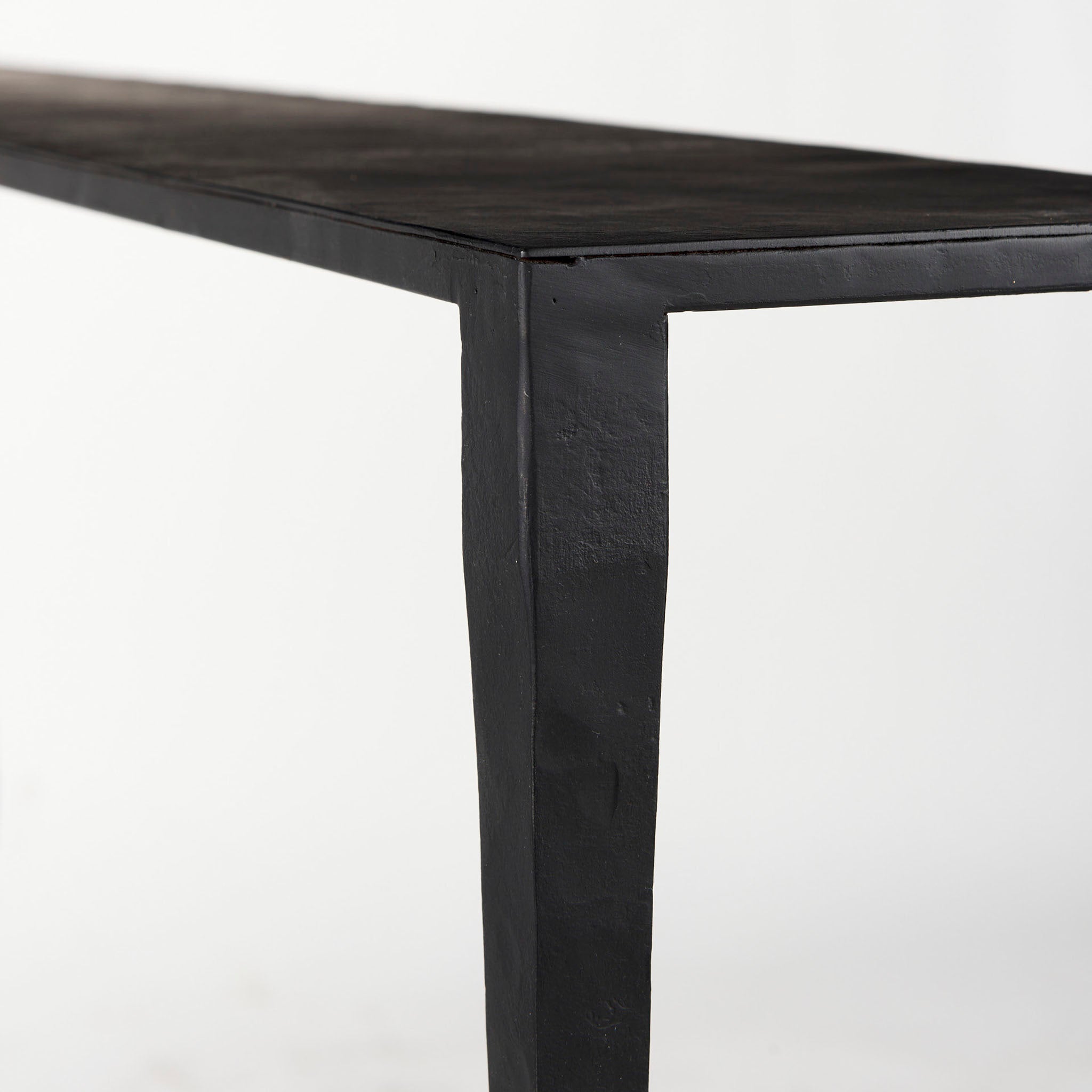 Black iron console table with narrow depth on a white background