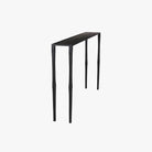 Black iron console table with narrow depth on a white background