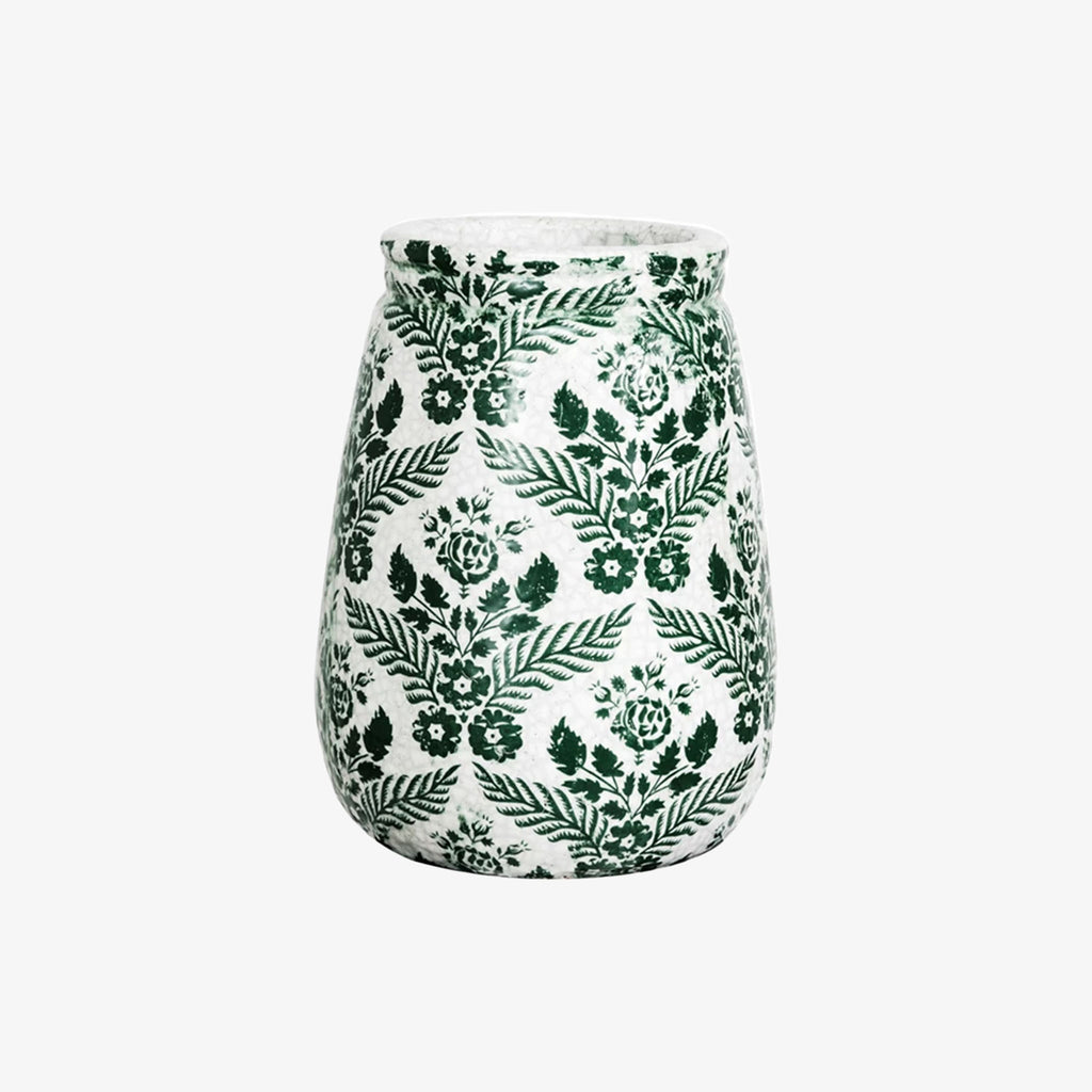 White vase with green floral transfer ware pattern  on a white background