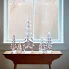 Vermont Evergreen Glass Trees on a table in front of a window at Addison West