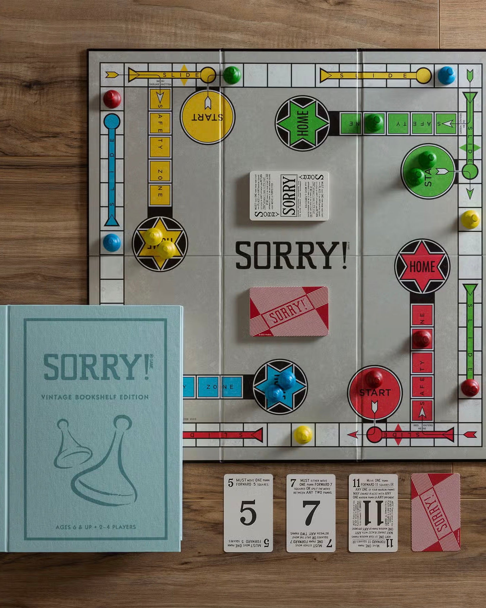 Vintage Bookshelf Edition Sorry! on a wood table displaying all the game components