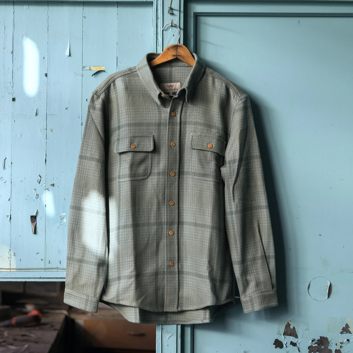 Warren Six Season Flannel in Lichen on a blue background at Addison West