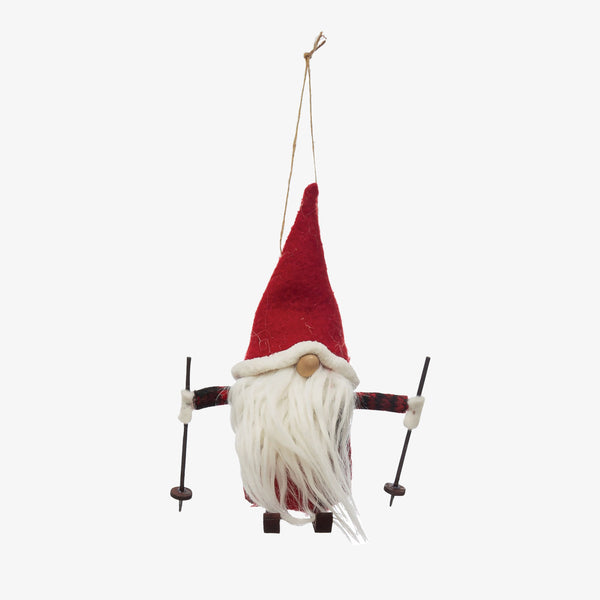 Skiing gnome ornament with red cap and white beard on a white background