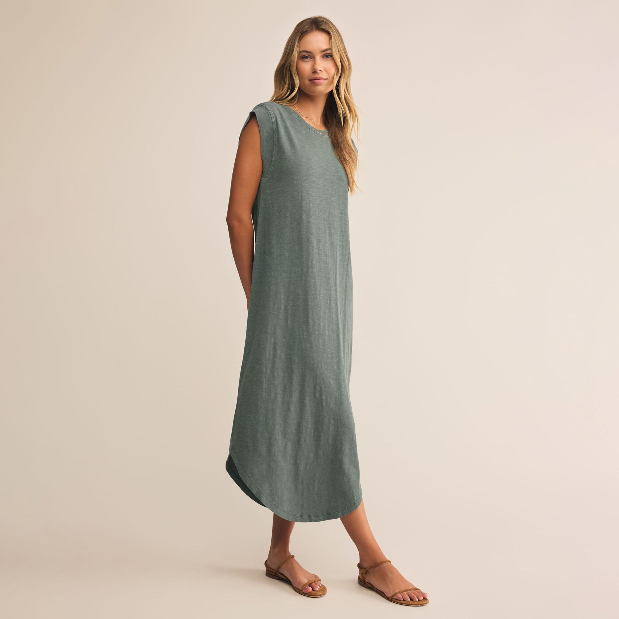 Model wearing Z Supply Calabasas Midi Dress Hunter Green against a beige background