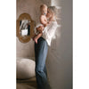 Model holding a baby and wearing a white sweater with Z Supply Cortez Pant in Supernova