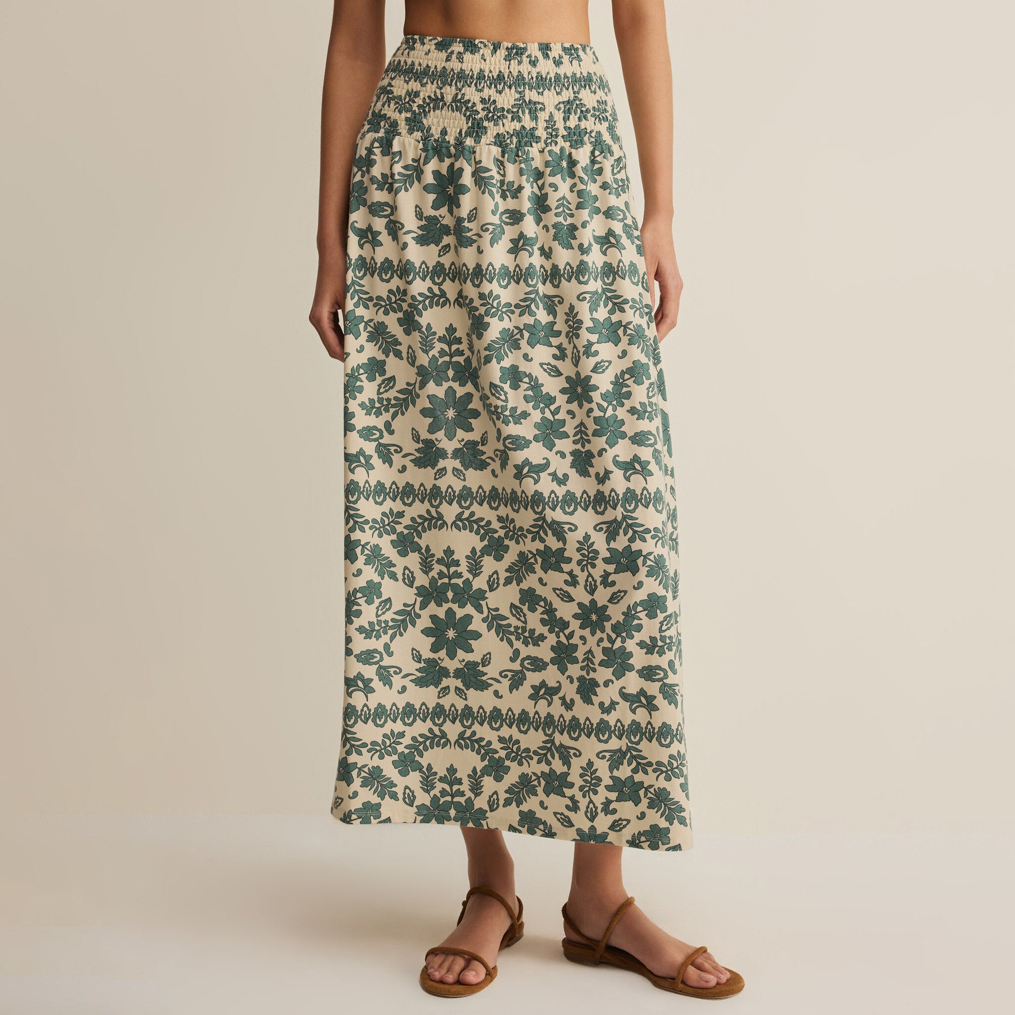 Woman wearing Z Supply Leya Tera Paisley Maxi Skirt in Everglade on plain background at Addison West.