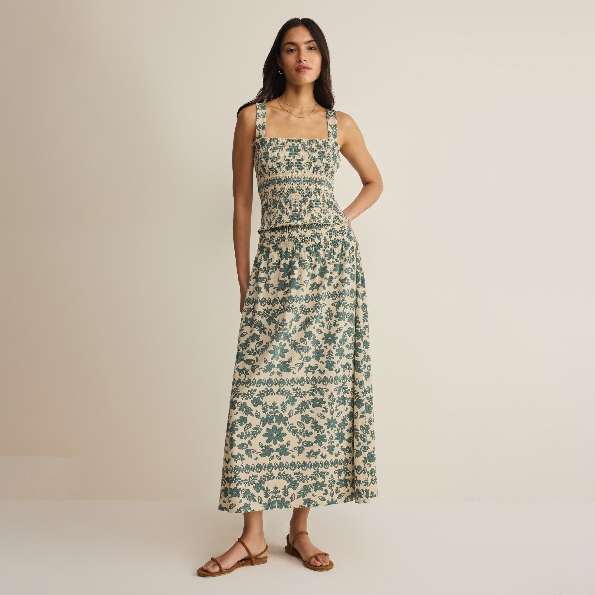 Woman wearing Z Supply Leya Tera Paisley Maxi Skirt in Everglade on plain background at Addison West.