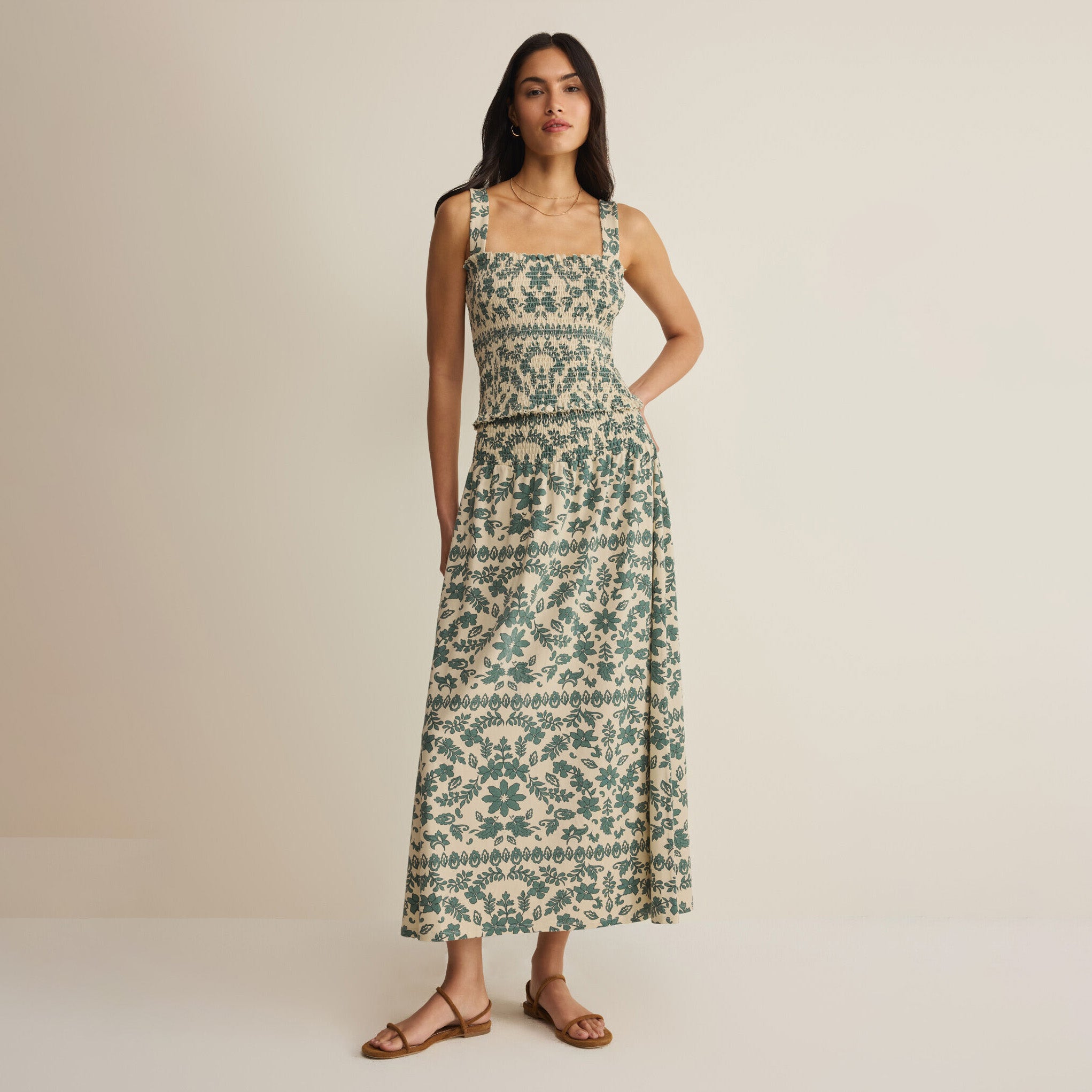 Woman wearing Z Supply Leya Tera Paisley Smocked Top in Everglade on plain background at Addison West.