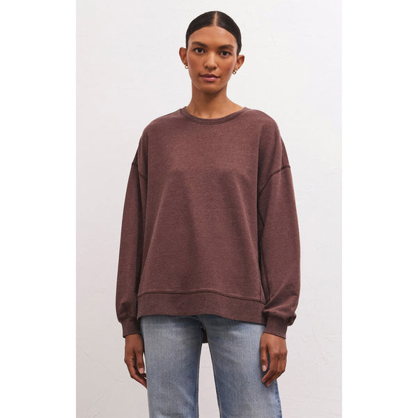 Model wearing jeans and Z Supply Modern Weekender in Dark Truffle in front of a white background