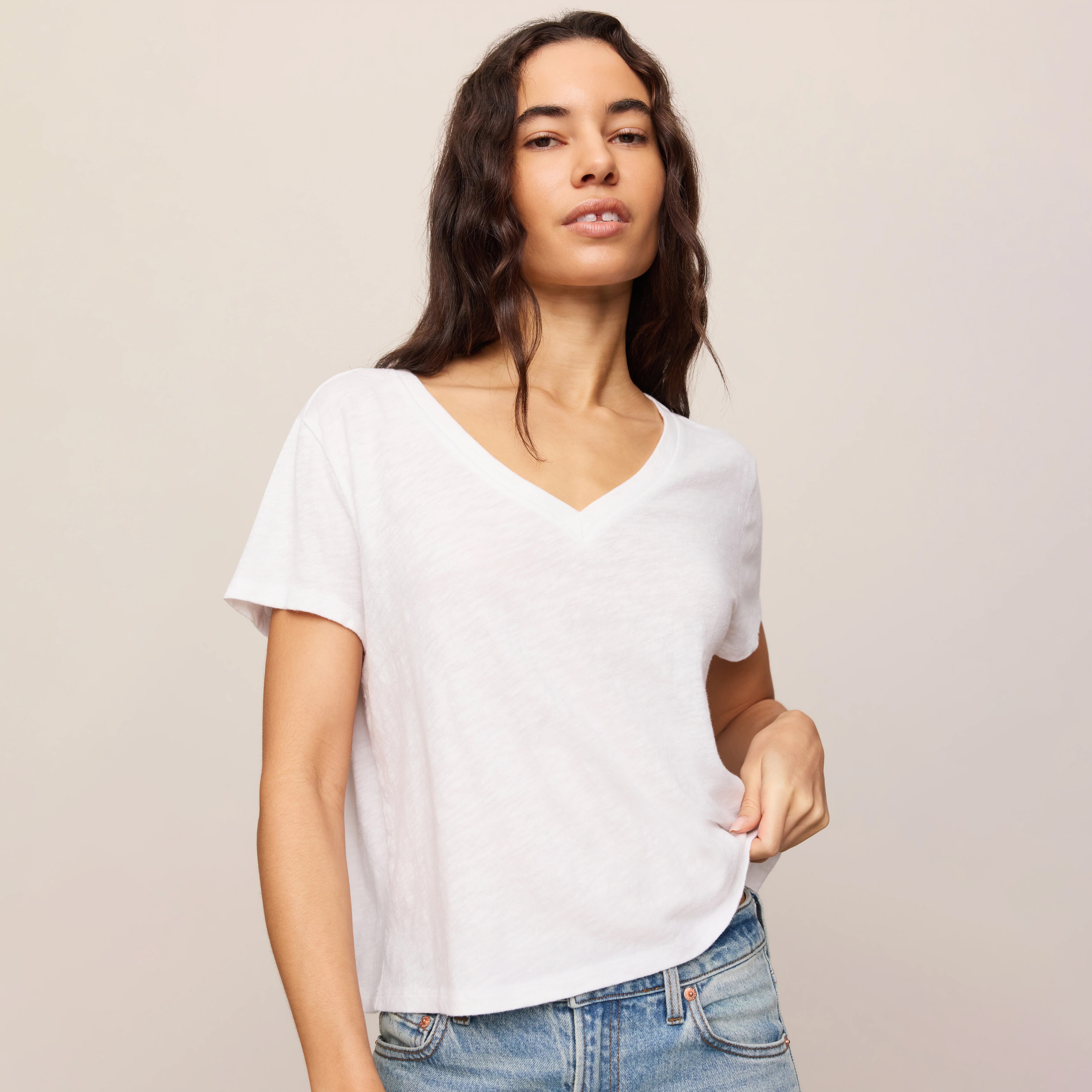 Z Supply Nomad V-Neck Tee in White shown on model on plain background.