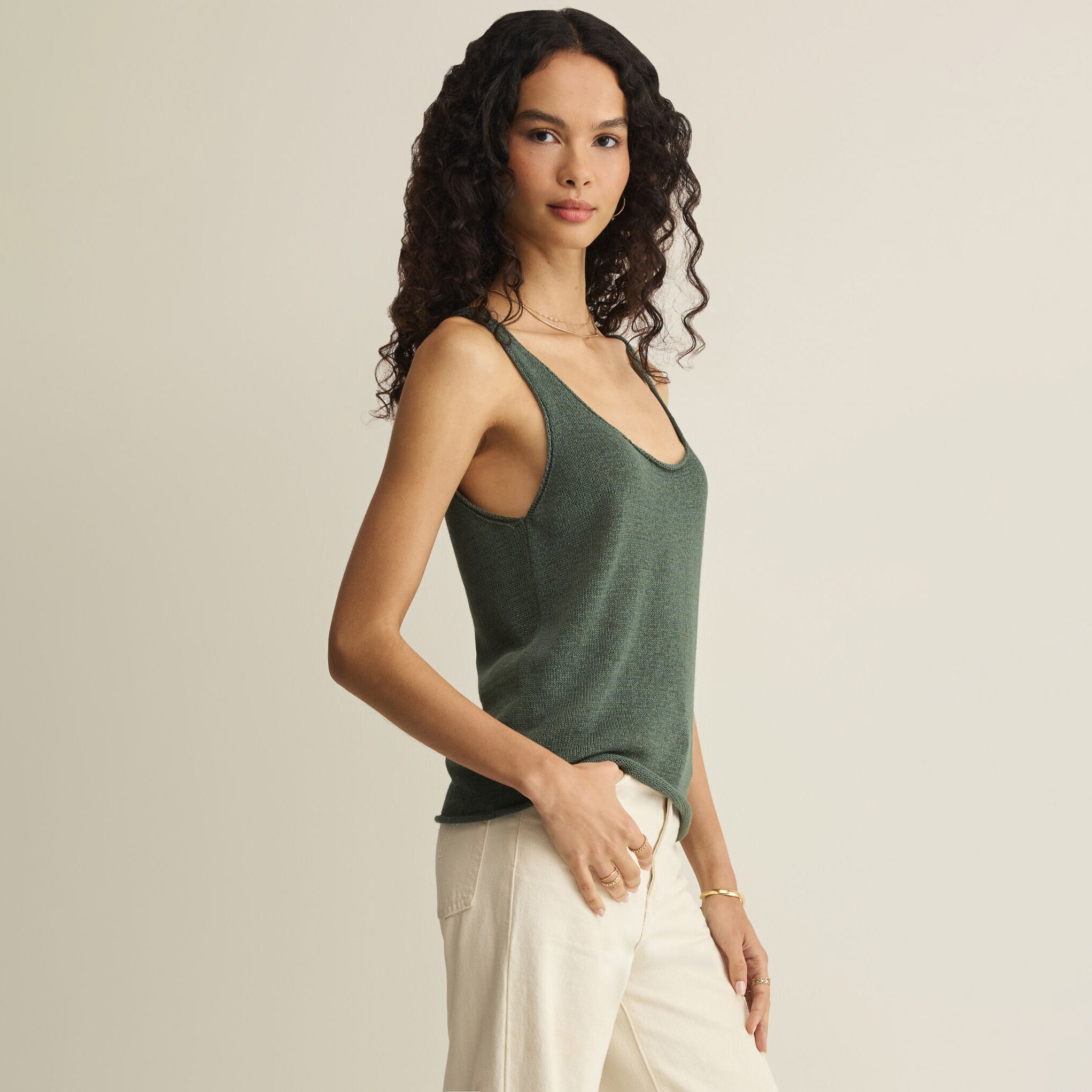 Woman wearing Z Supply Perch Sweater Tank in Everglade on plain background at Addison West.