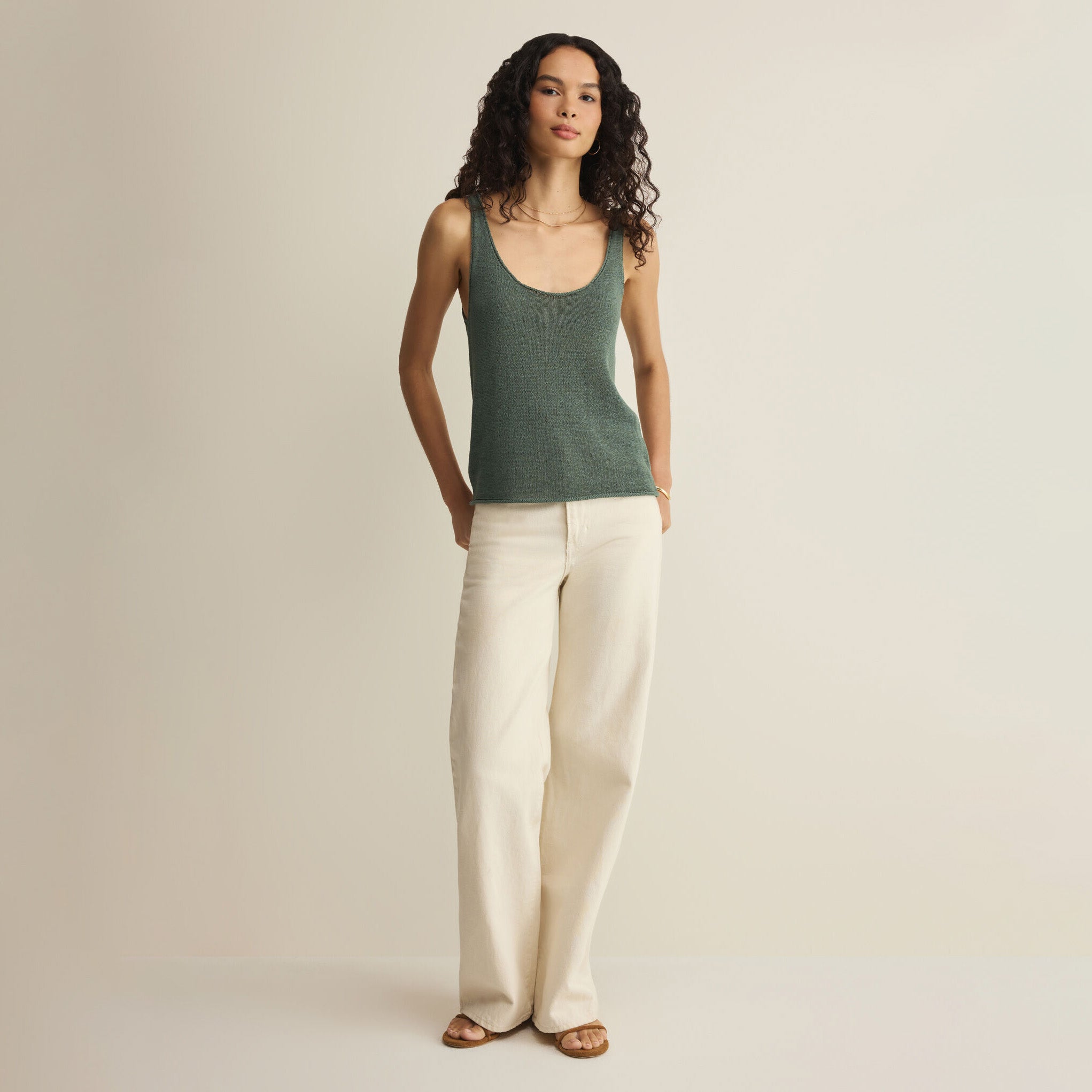 Woman wearing Z Supply Perch Sweater Tank in Everglade on plain background at Addison West.
