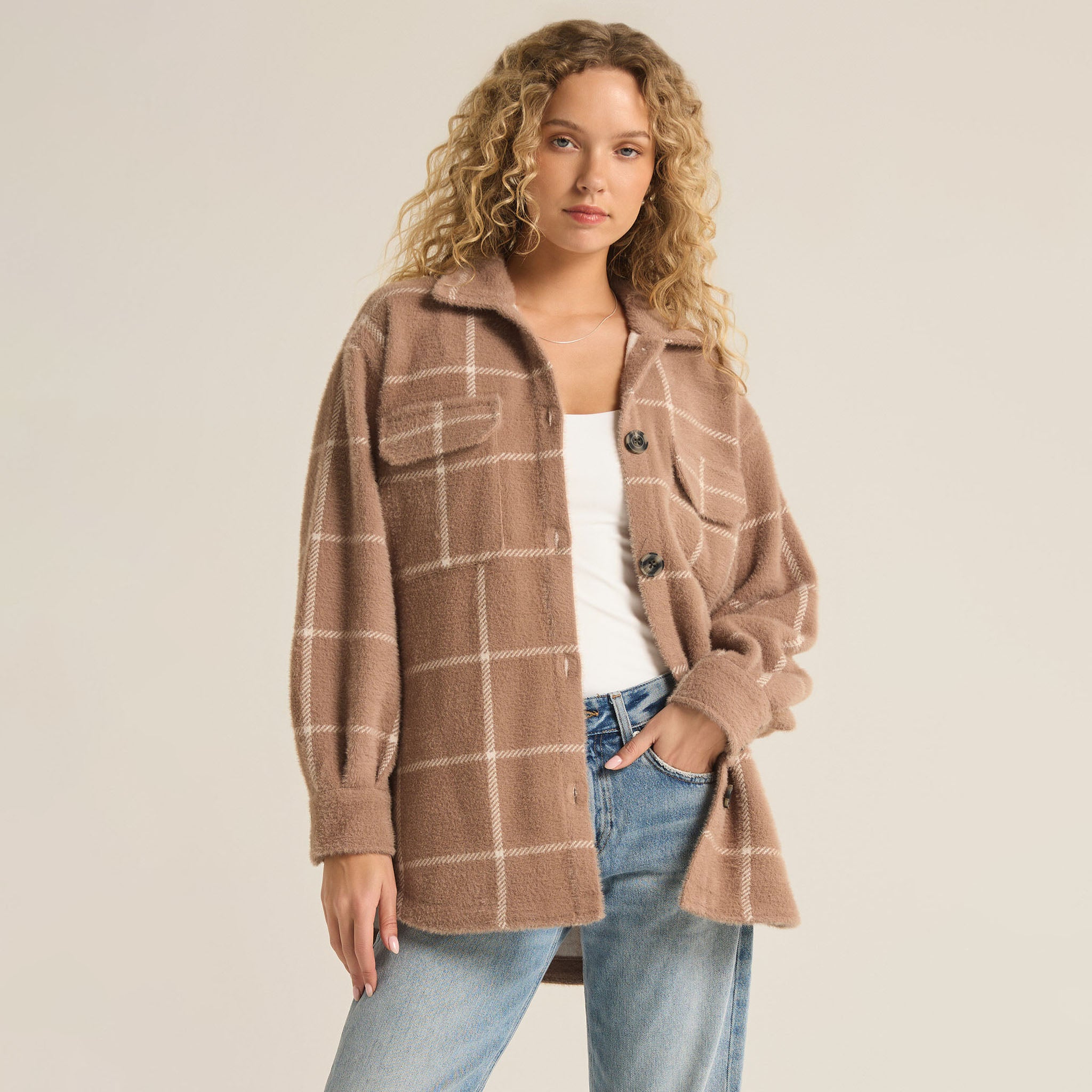 Woman wearing Z Supply Plaid Tucker Jacket in Heather Taupe with jeans in front of a plain background