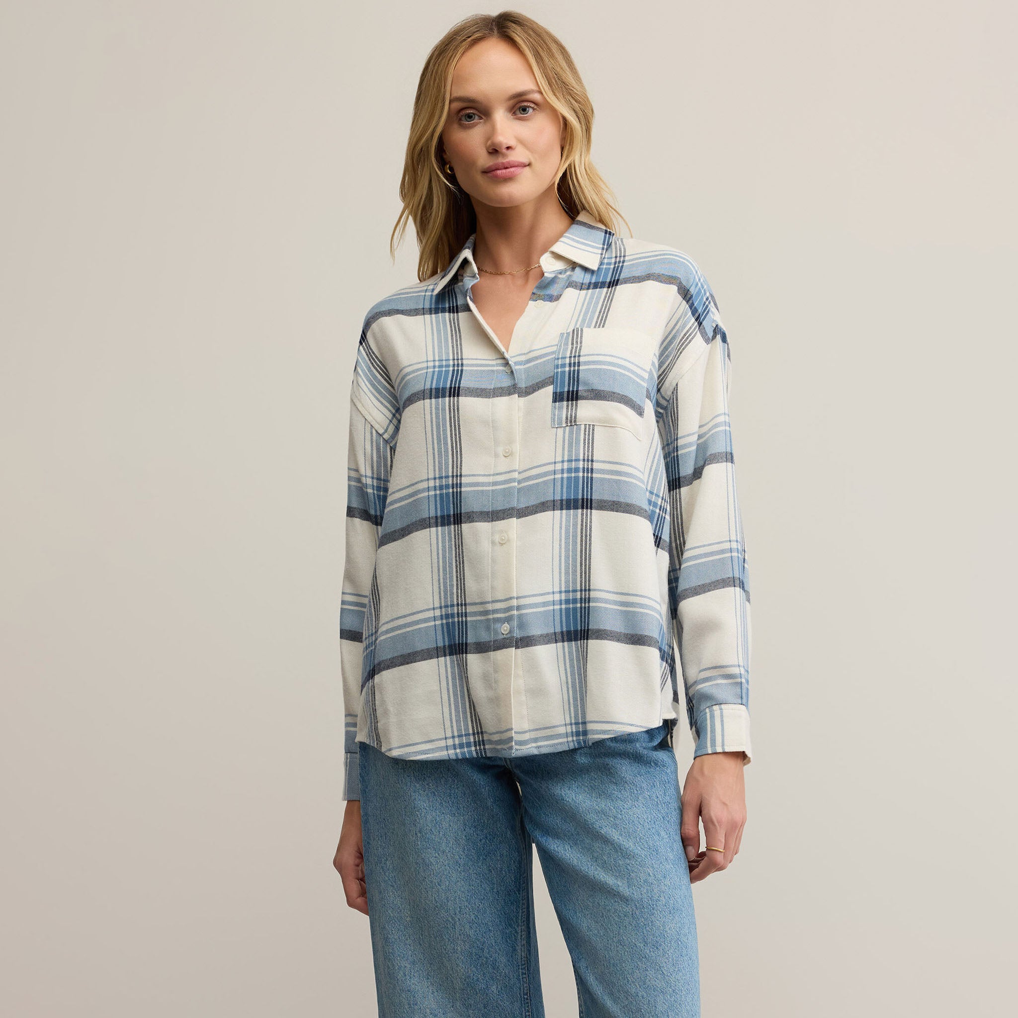 Z Supply River Plaid Button Up in Vintage Indigo on a beige background at Addison West