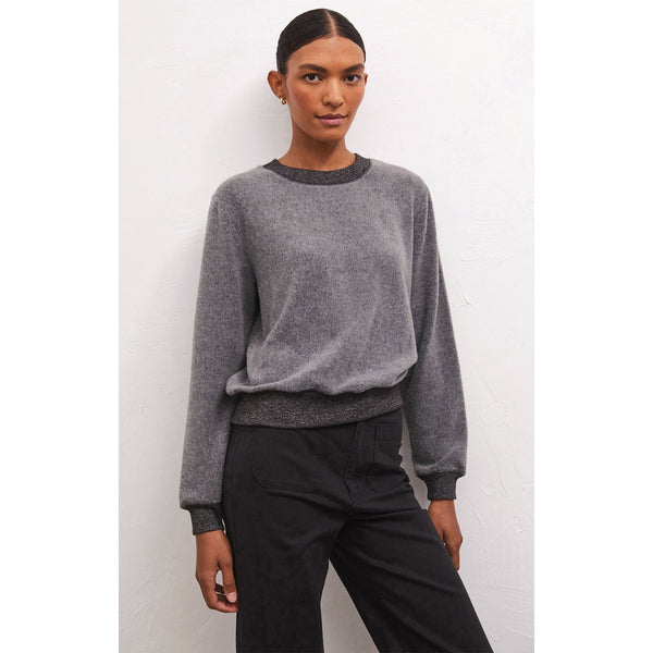 Model wearing black pants and Z Supply Russel Cozy Pullover in Charcoal in front of a white wall