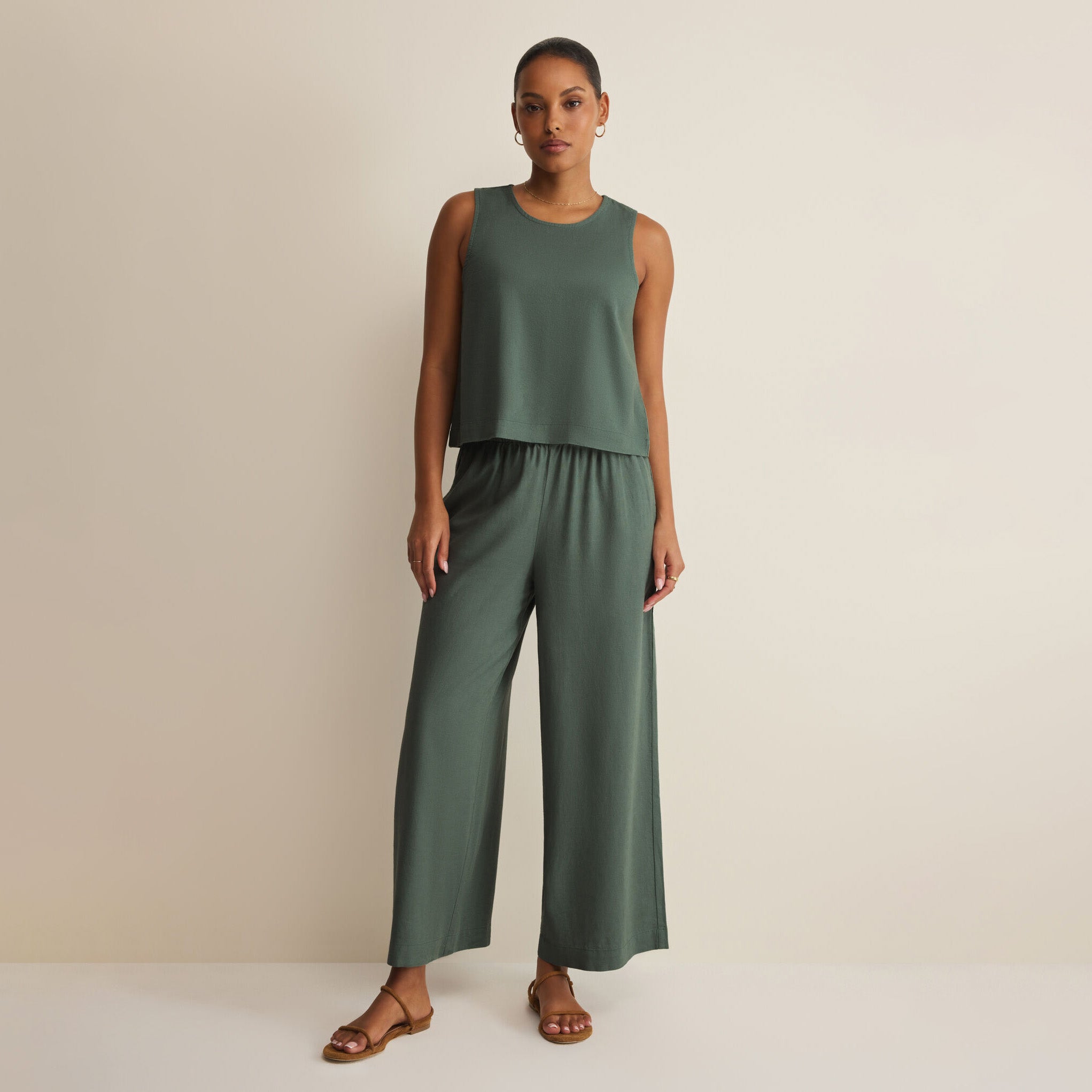 Woman wearing Z Supply Scout Linen Pants in Everglade on plain background at Addison West.
