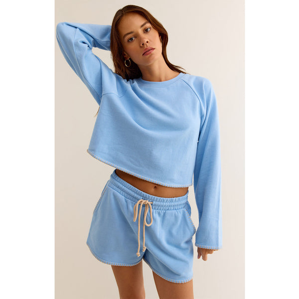 Model wearing Z Supply Seville Cropped Sweatshirt Surf Blue with matching shorts 