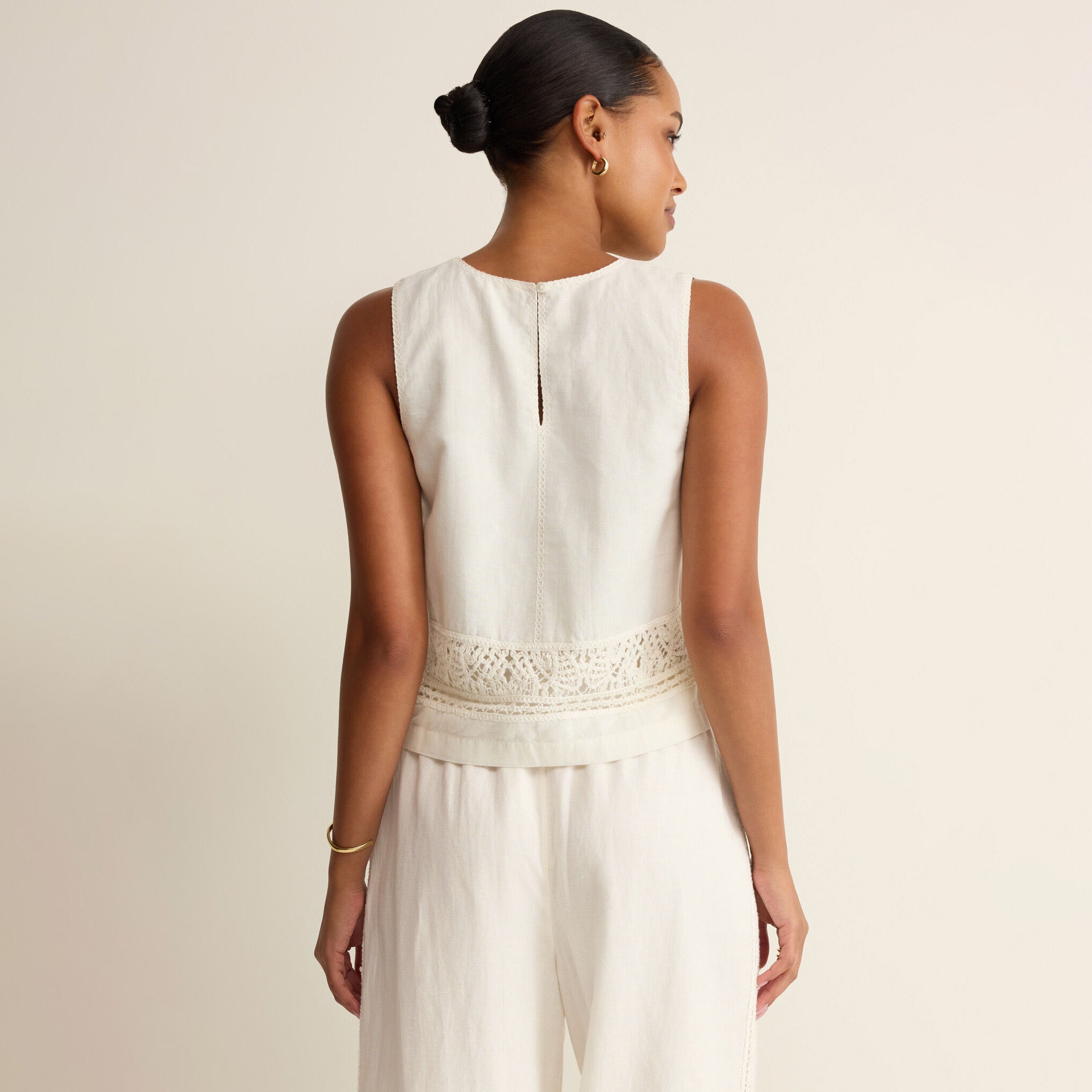 Woman wearing Z Supply Sloane Embroidered Top in White on plain background at Addison West.