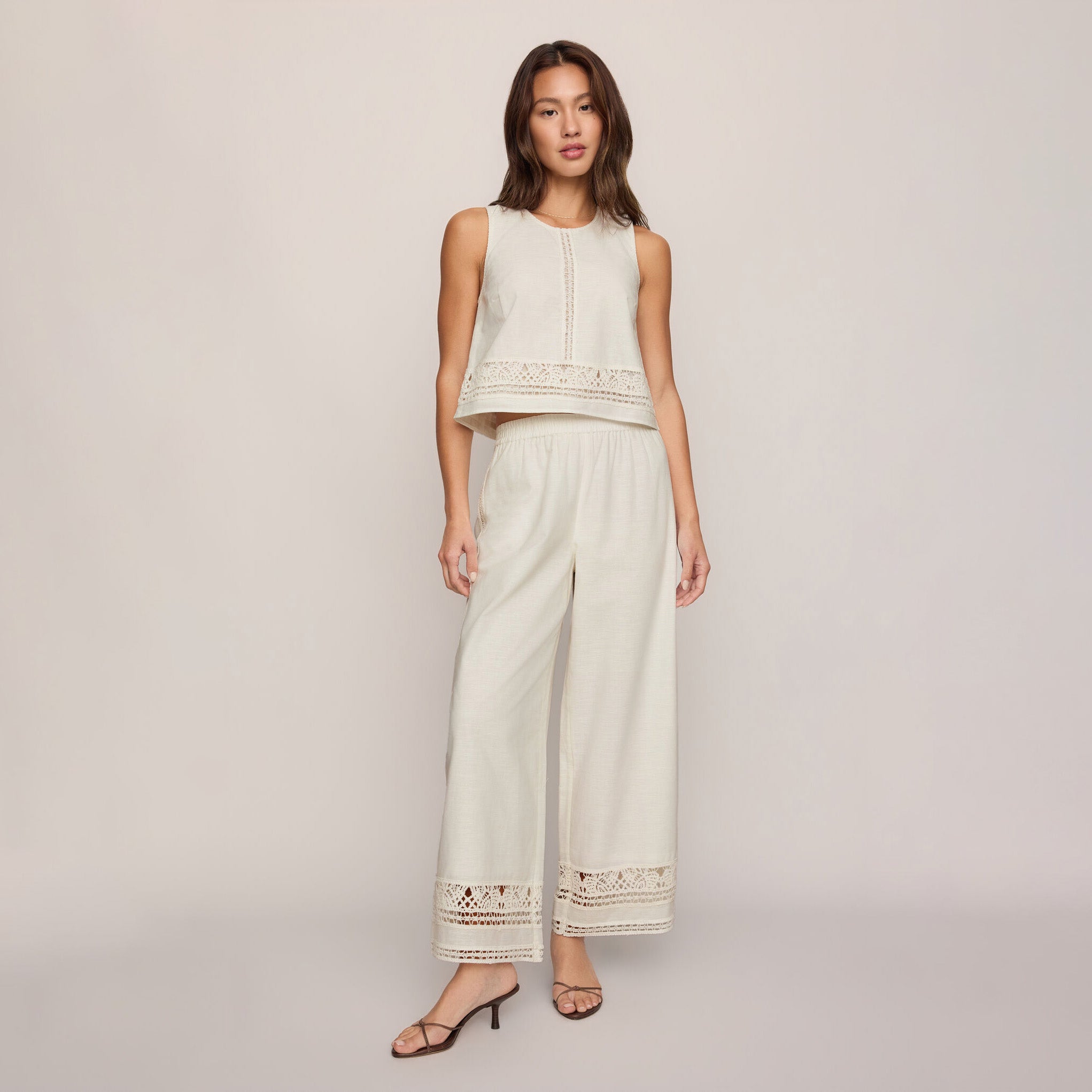 Woman wearing Z Supply Sloane Embroidered Top in White on plain background at Addison West.