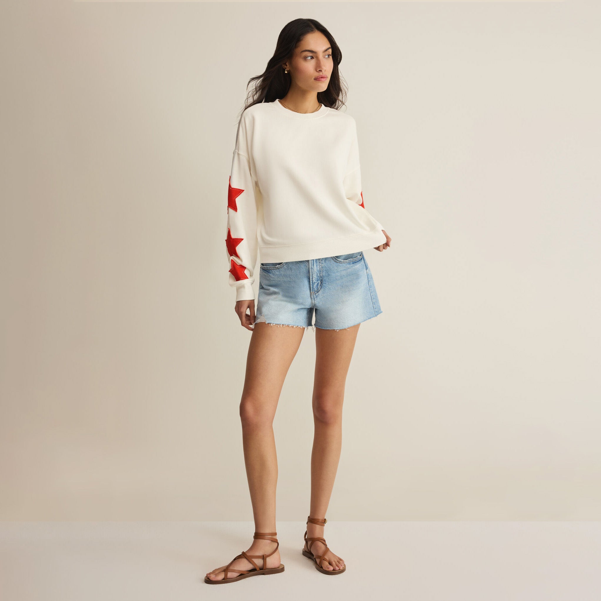 Woman wearing Z Supply Stars First Date Sweatshirt in Sea Salt on plain background at Addison West.