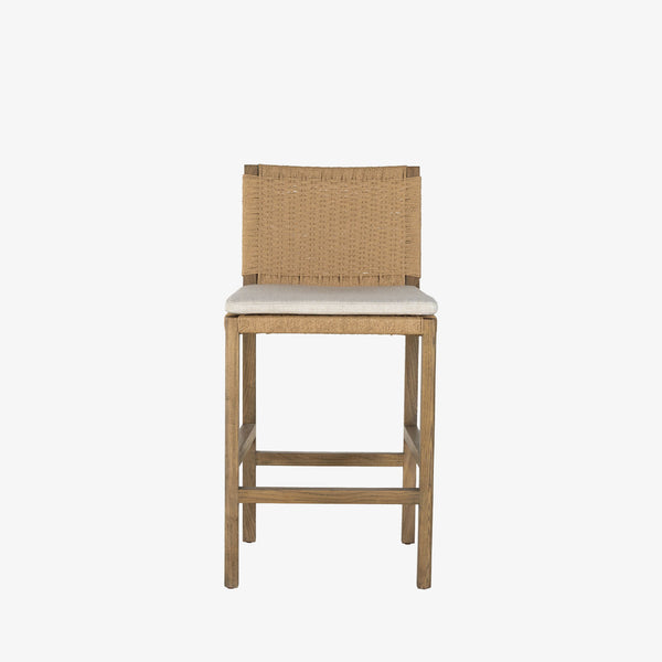 Four Hands Zuma bar stool with beige cushion and woven back in Dune Ash on a white background