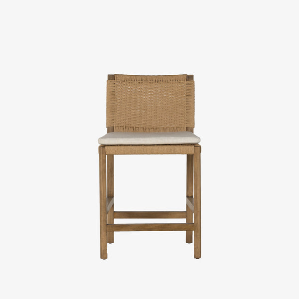 Four Hands Zuma counter stool with beige cushion and woven back in Dune Ash on a white background