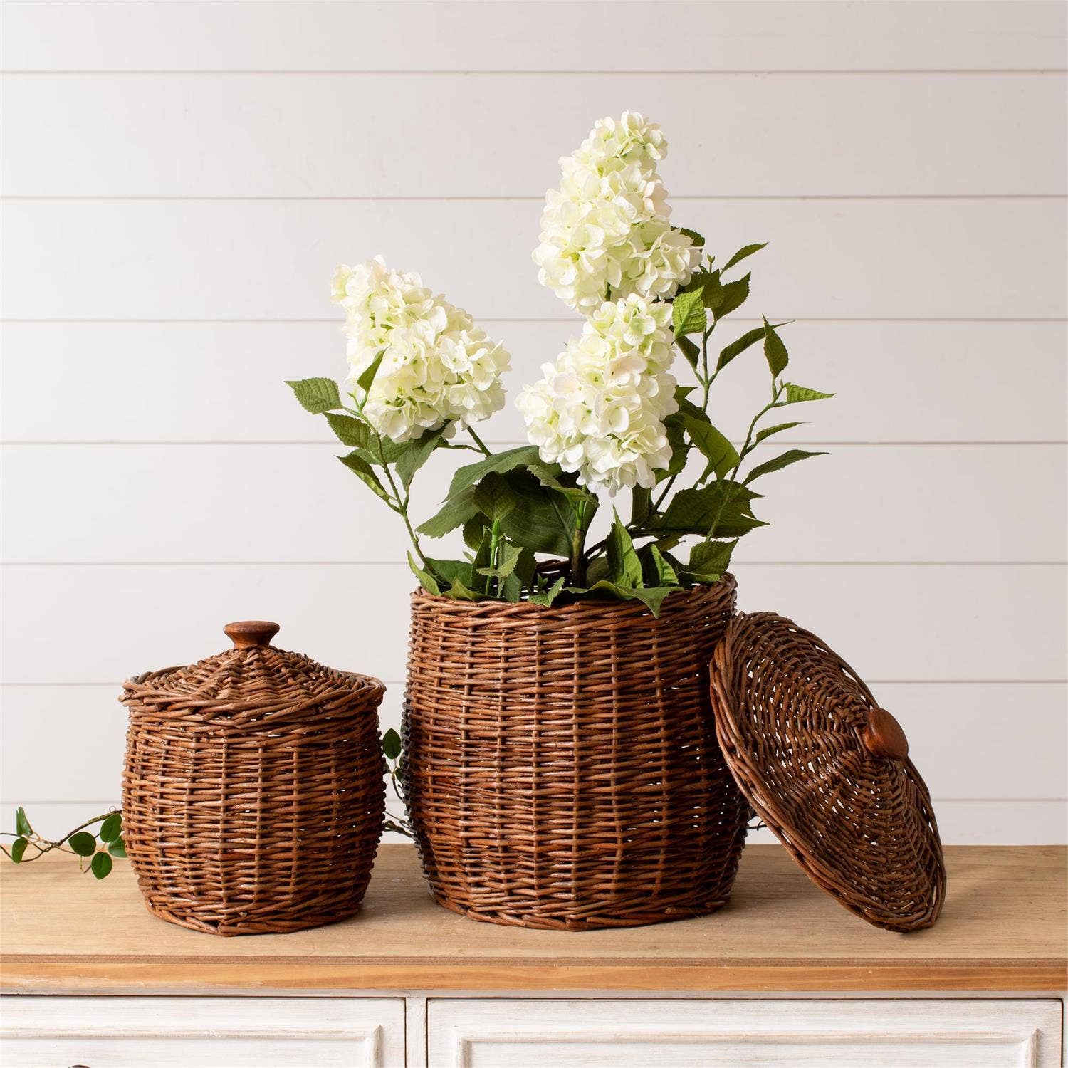 Wicker Storage Baskets With Lids on a table with flowers at Addison West