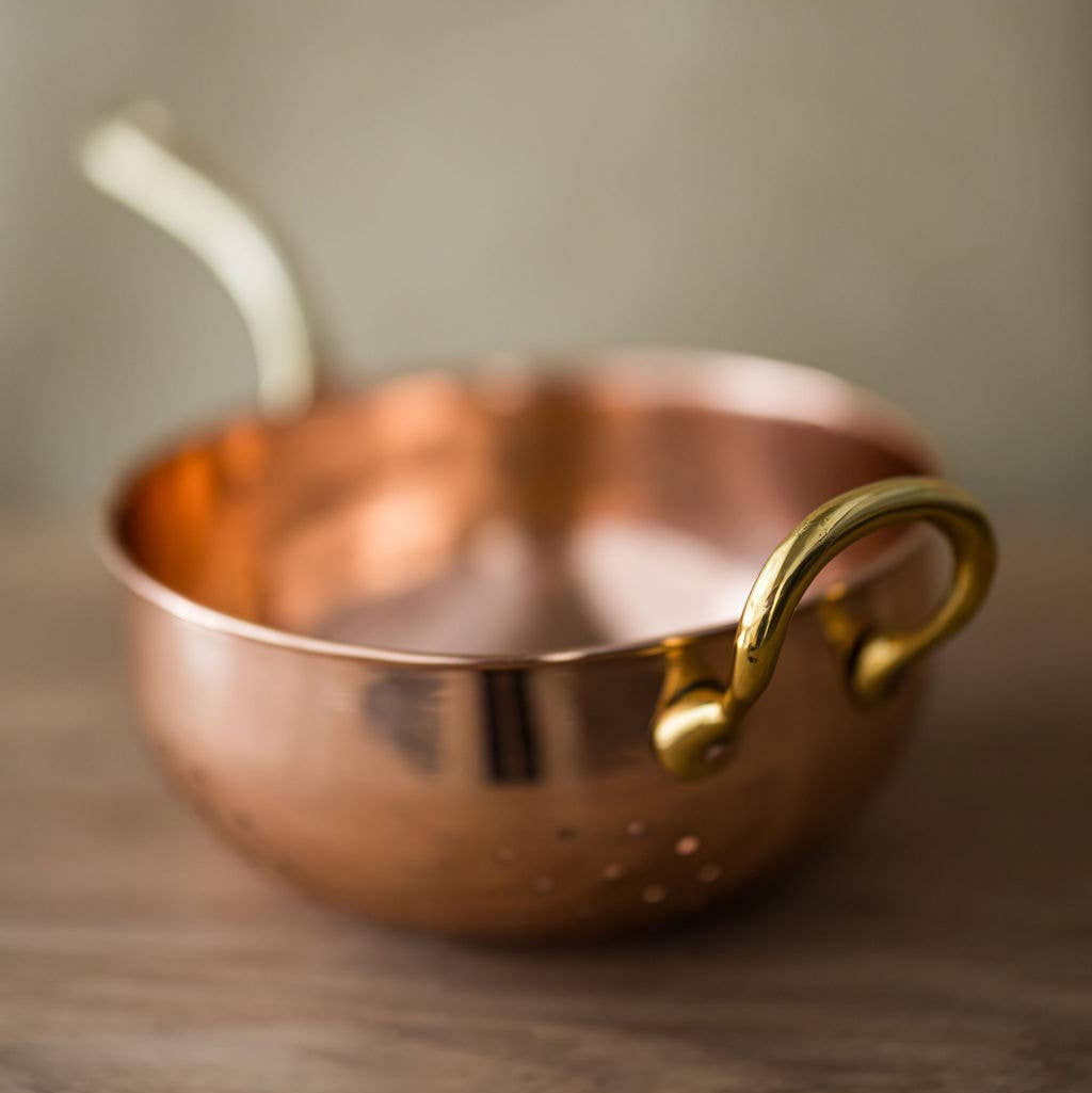 Galley and Fenn Copper Colander on a wood table at Addison West