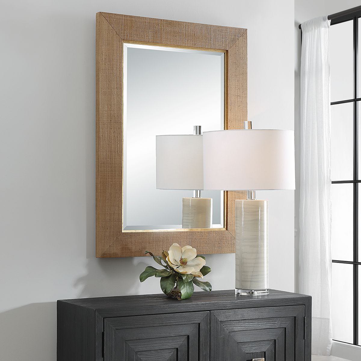 Buxley Accent Mirror on a white wall above a table at Addison West