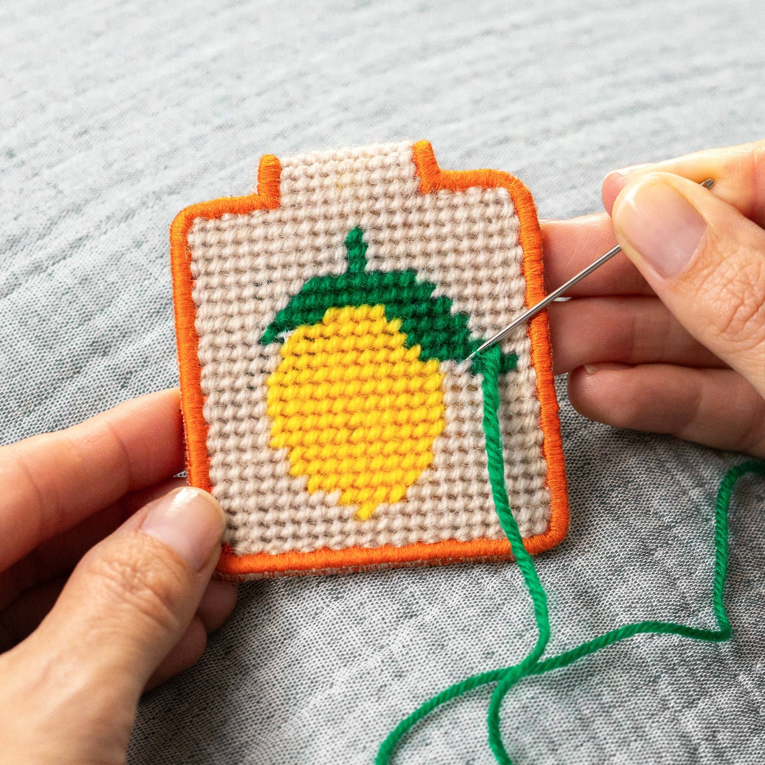 Lemon Needlepoint Keychain Kit on a grey background at Addison West