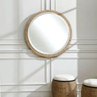 Carsten Round Accent Mirror on a white wall in a living room at Addison West