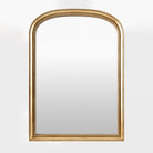 Nalanda Mantel Mirror in Antiqued Gold on a white background at Addison West
