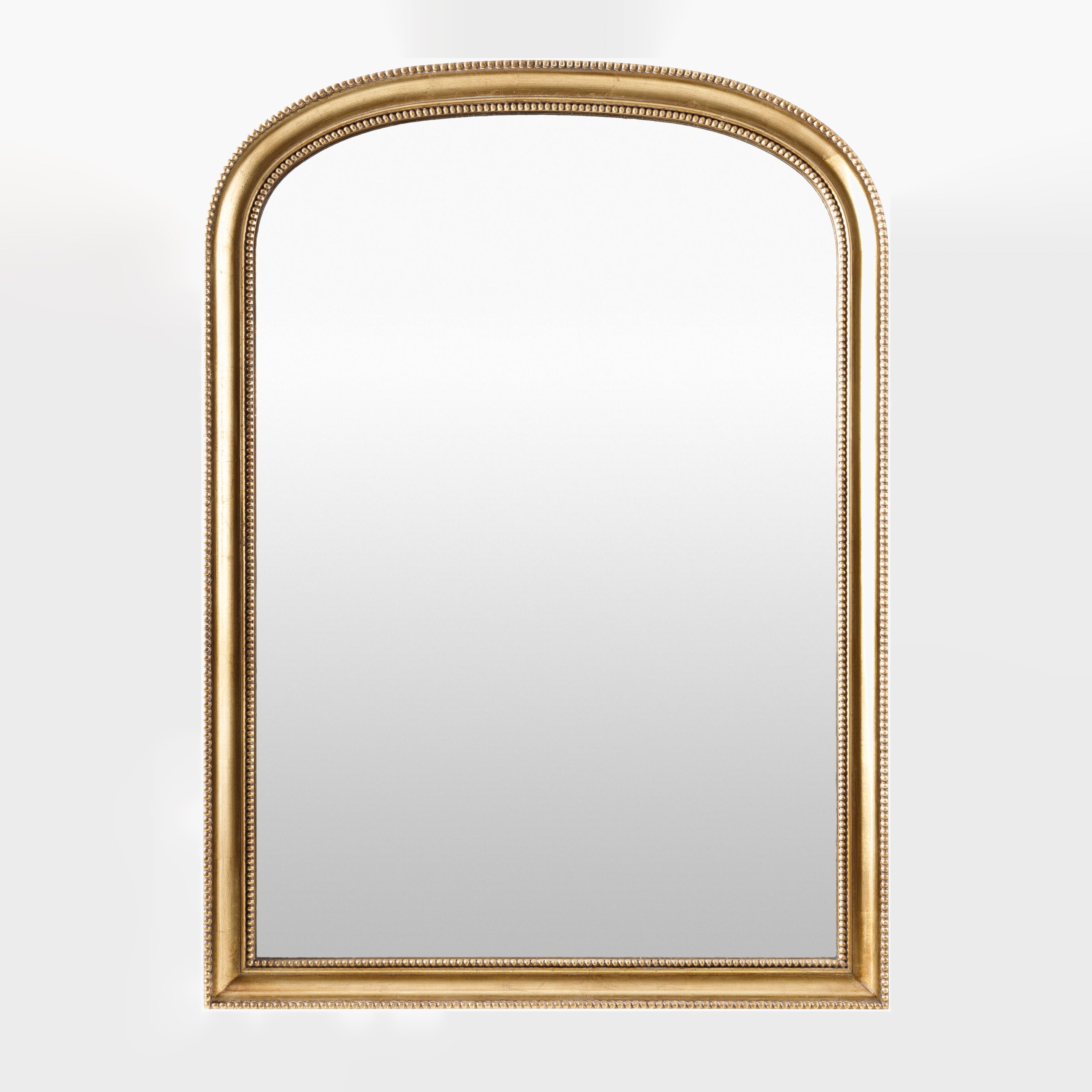 Nalanda Mantel Mirror in Antiqued Gold on a white background at Addison West