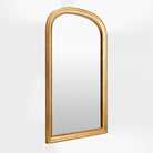 Nalanda Mantel Mirror in Antiqued Gold on a white background at Addison West