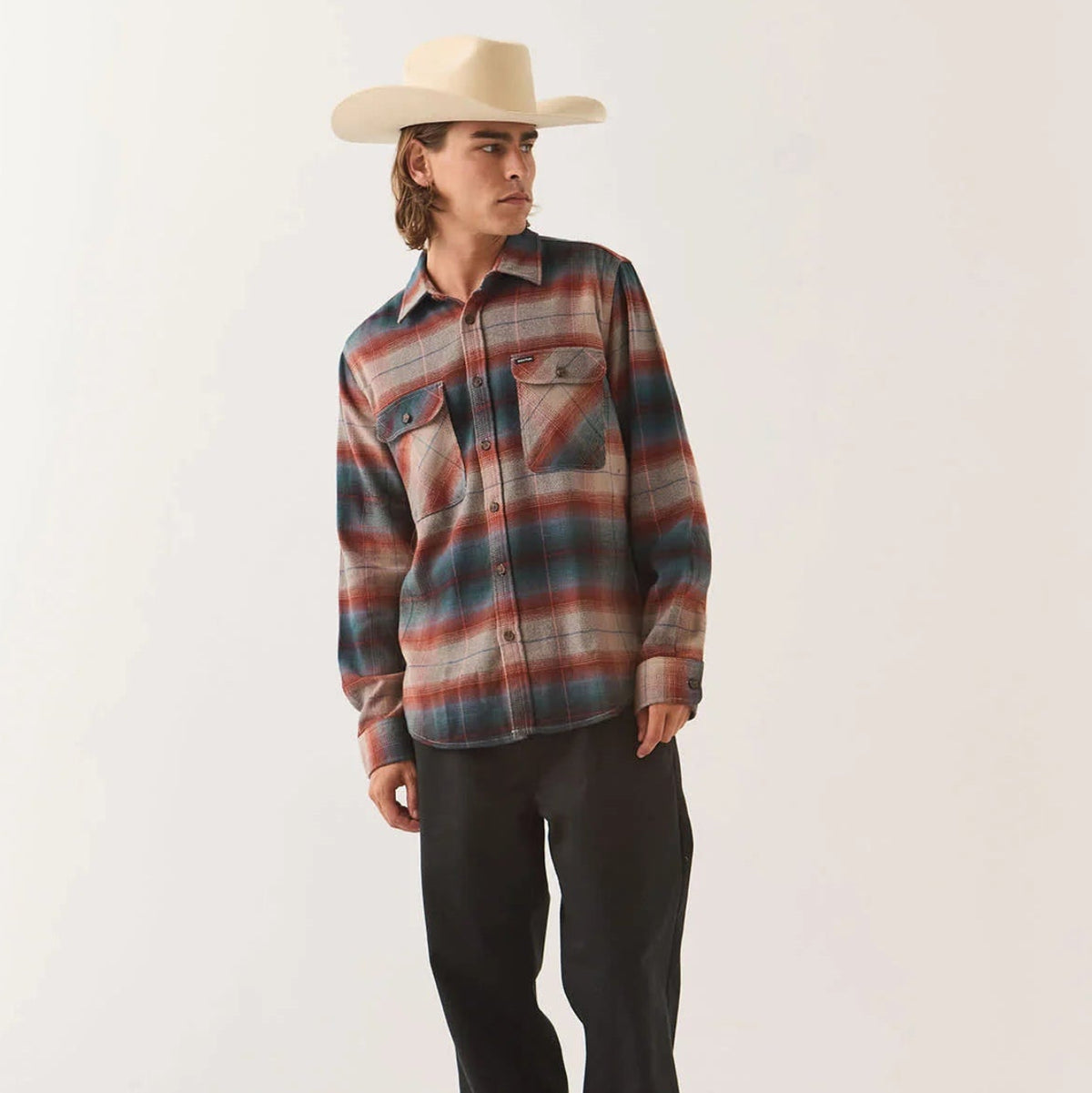 Male model wearing the Brixton Men's Bowery Flannel in Multi Shadow on plain background.