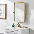 Burnish Accent Mirror in Antiqued Gold on a white wall in a bathroom at Addison West