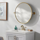 Burnish Round Accent Mirror in Antiqued Gold on a white wall in a bathroom at Addison West