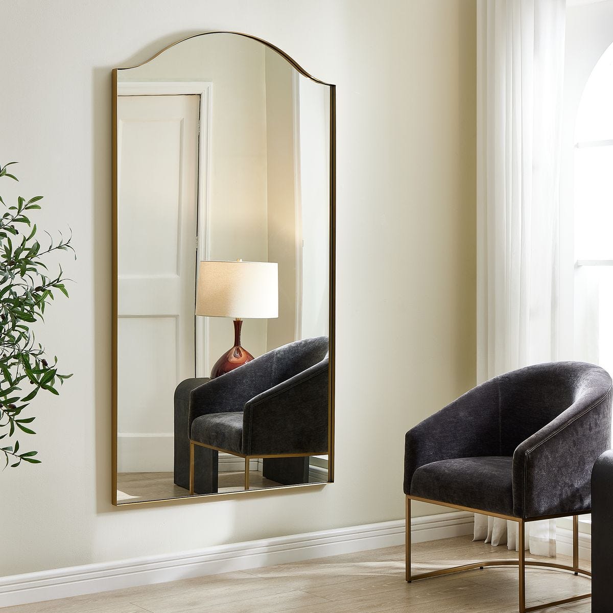 Mallorin Arch Full Length Mirror on a white wall in a living room at Addison West