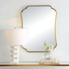 Atwell Accent Mirror on a white wall above a table at Addison West