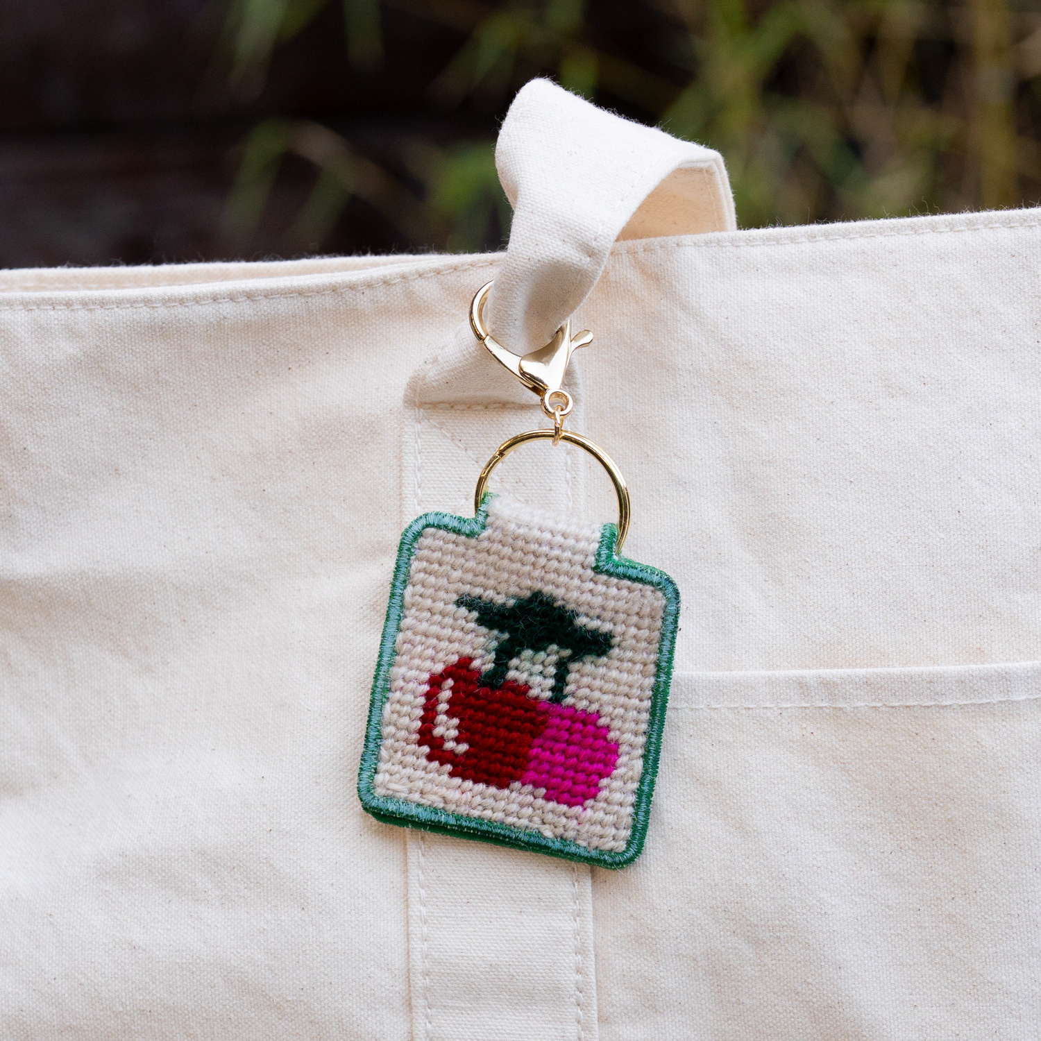 Cherries Needlepoint Keychain Kit on a bag at Addison West