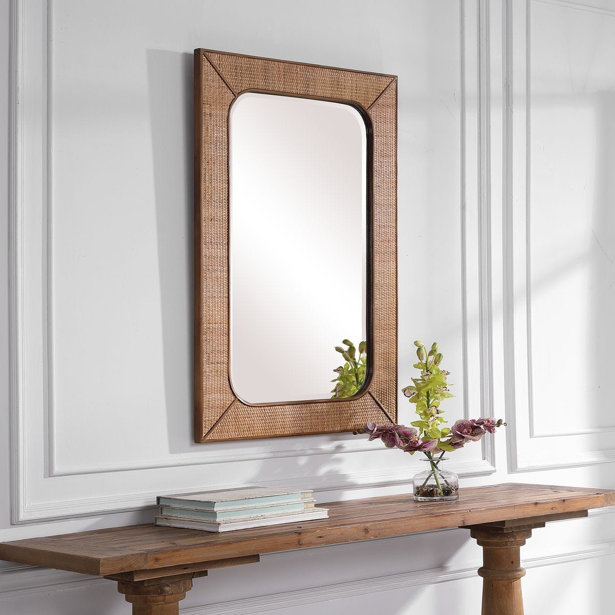 Tamera Accent Mirror on a white wall above a table at Addison West